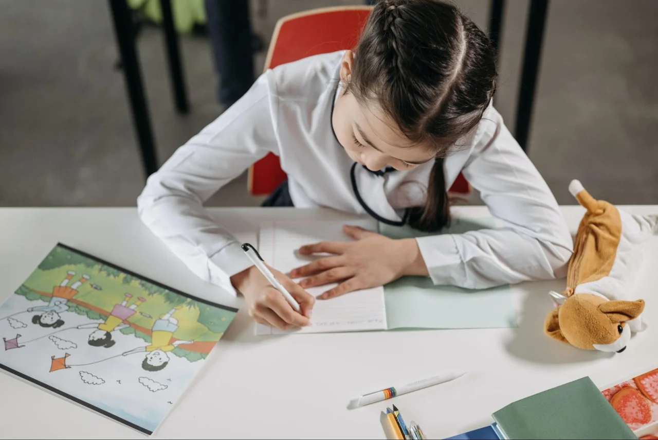A child writing at a desk